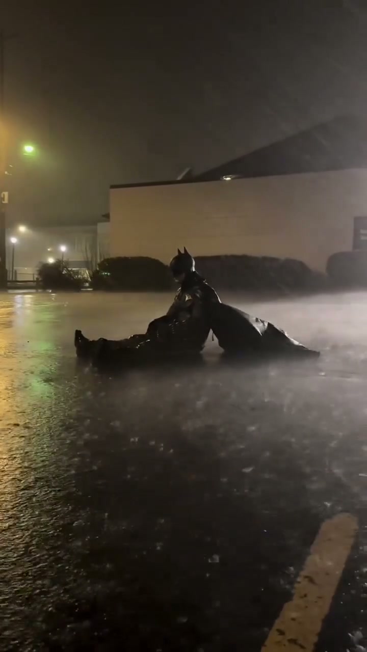 Batman sitting in the rain