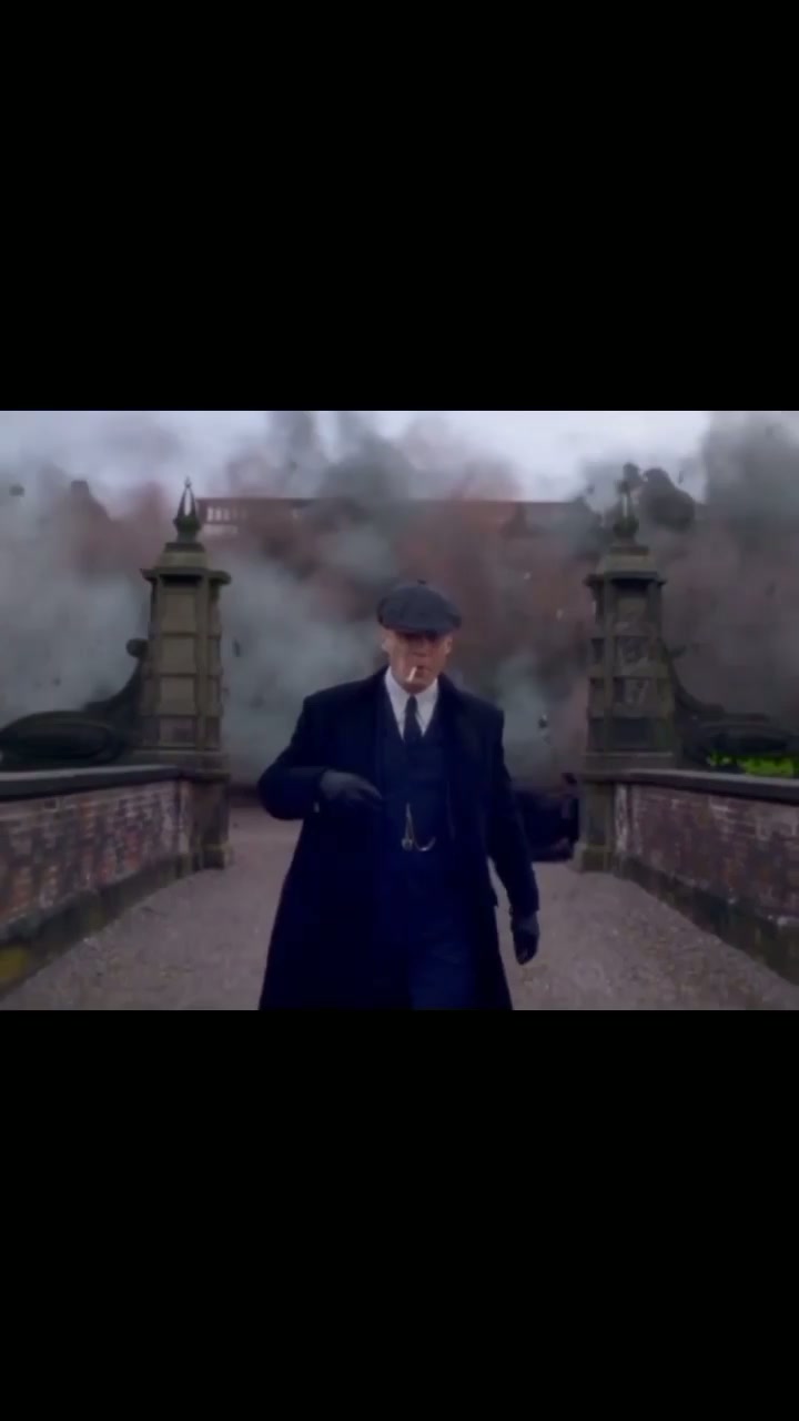 Thomas Shelby walking away from an explosion