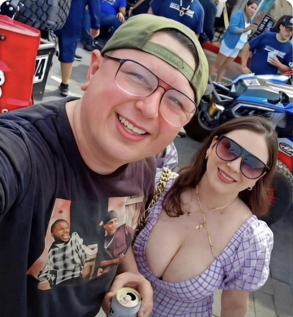 A man and woman posing for a selfie