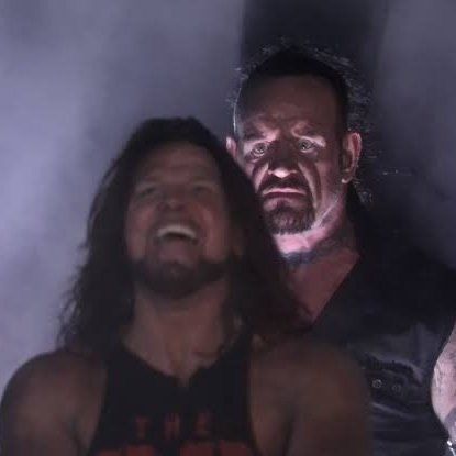 Undertaker looming behind AJ Styles