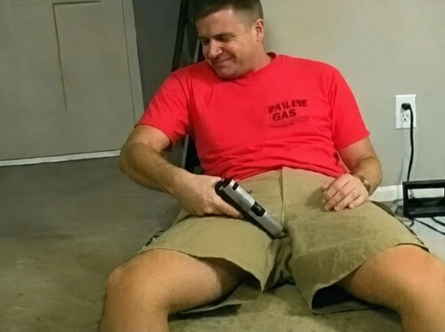 Idiot pointing a gun at his junk